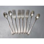 Four American sterling iced tea spoons, signed Cartier and a similar set of four table forks, 13oz.