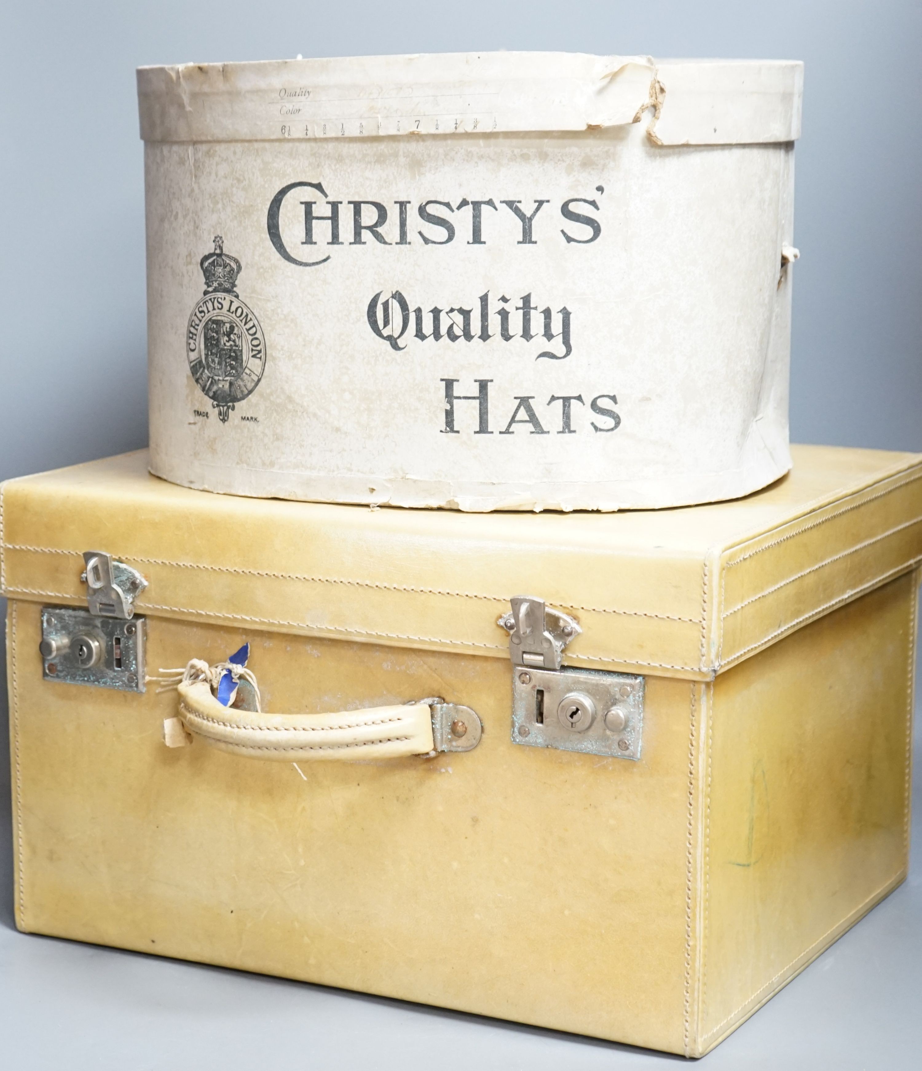 A top hat (boxed) and a cream vanity case