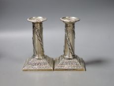 A pair of early 20th century repousse silver dwarf candlesticks, Thomas Bradbury & Sons,