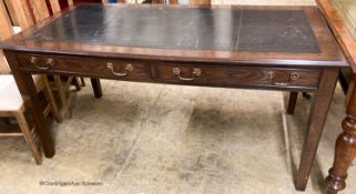 A reproduction oak two drawer writing table, W.160cm D.80cm H.78cm