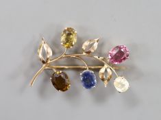 A yellow metal and multi gem set (including sapphire, tourmaline and garnet) floral spray brooch,
