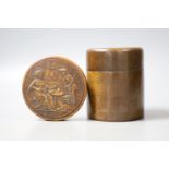 A French press moulded burr wood snuff box of circular form, decorated in semi-relief to the top