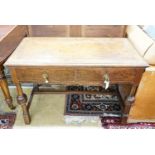 A 1920's oak two drawer writing table, with a leather inset top, length 106cm, depth 52cm, height