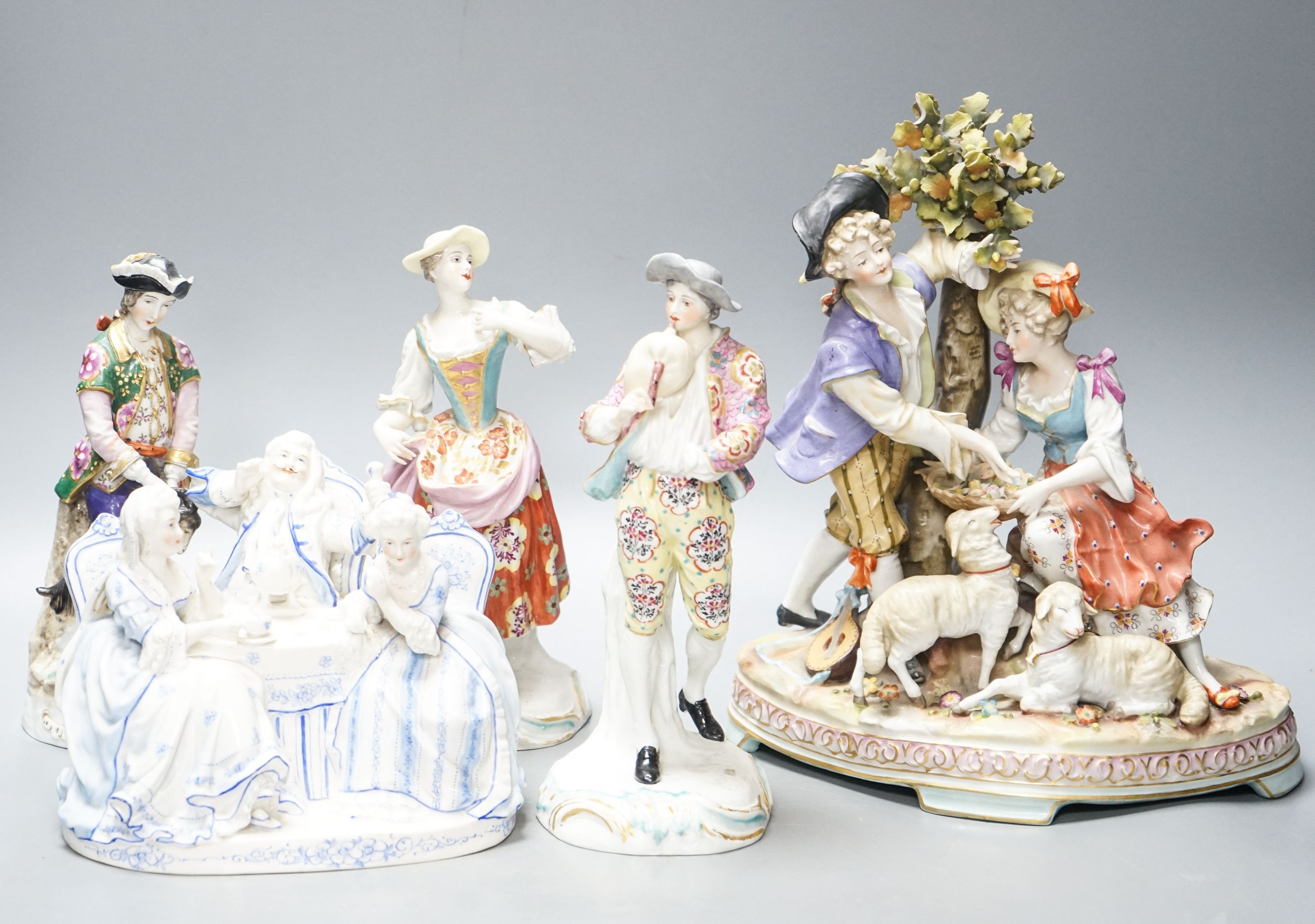 A Sitzendorf group of a Shepherd and shepherdess, three other Continental costume figures and a