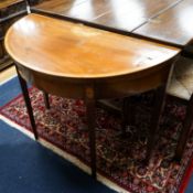 A George III inlaid and cross banded mahogany demi-lune card table with folding top, width 91cm,