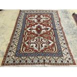 A Caucasian design red ground rug, 240 x 165 cms.