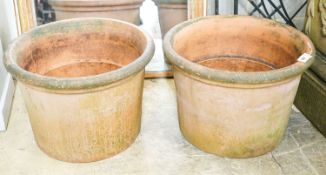 A near pair of large circular terracotta garden planters, diameter 64cm, height 45cm