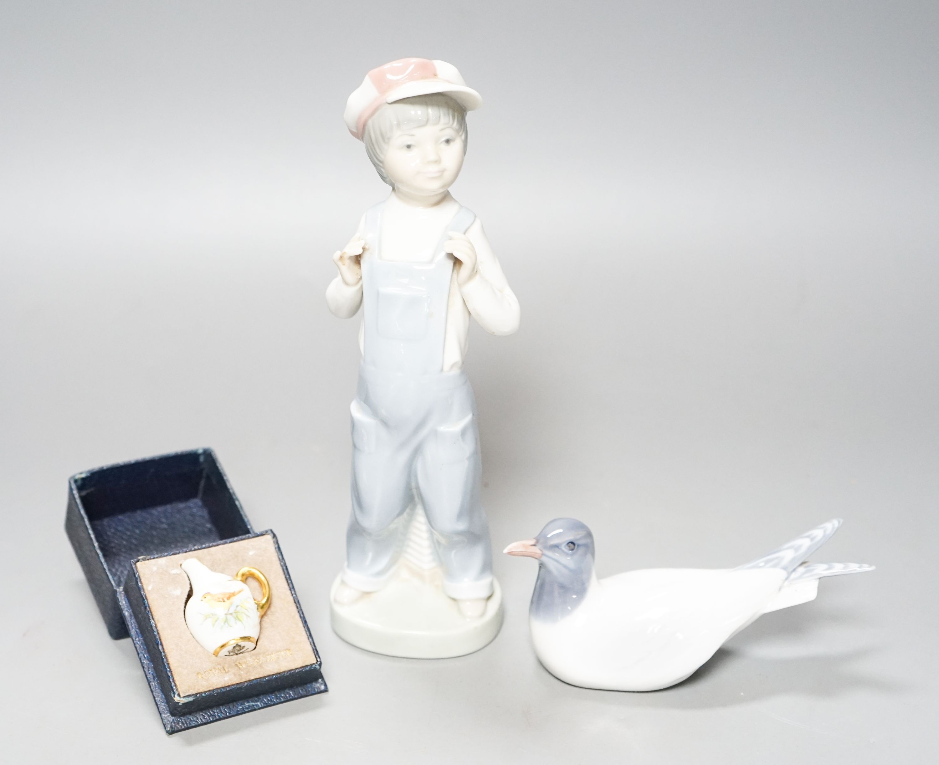 A Lladro figure of a young boy, 21.5cm high, a Royal Copenhagen model a tern, a cased miniature