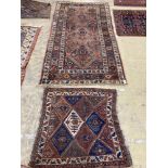 An antique Caucasian red ground rug, 250 x 125 cm and a smaller Shiraz rug.