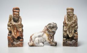 A pair of Chinese soapstone figures of immortals, modelled seated on rocky bases and a similar