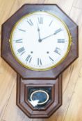 A mahogany octagonal dial clock with key and pendulum60cm