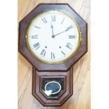 A mahogany octagonal dial clock with key and pendulum60cm