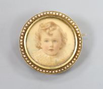 An early 20th century yellow metal and split pearl set circular brooch, inset with portrait of a