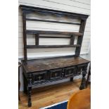 An 18th century and later oak dresser, the base fitted two drawers on turned supports, with two-tier