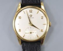 A gentleman's 9ct gold Omega manual wind wrist watch, on associated leahet strap, with case back