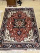 A Heriz style brick red ground rug, 206 x 150cm