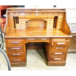 An early 20th century oak roll top desk with 'S' shape tambour, width 140cm, depth 80cm, height