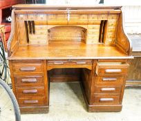 An early 20th century oak roll top desk with 'S' shape tambour, width 140cm, depth 80cm, height