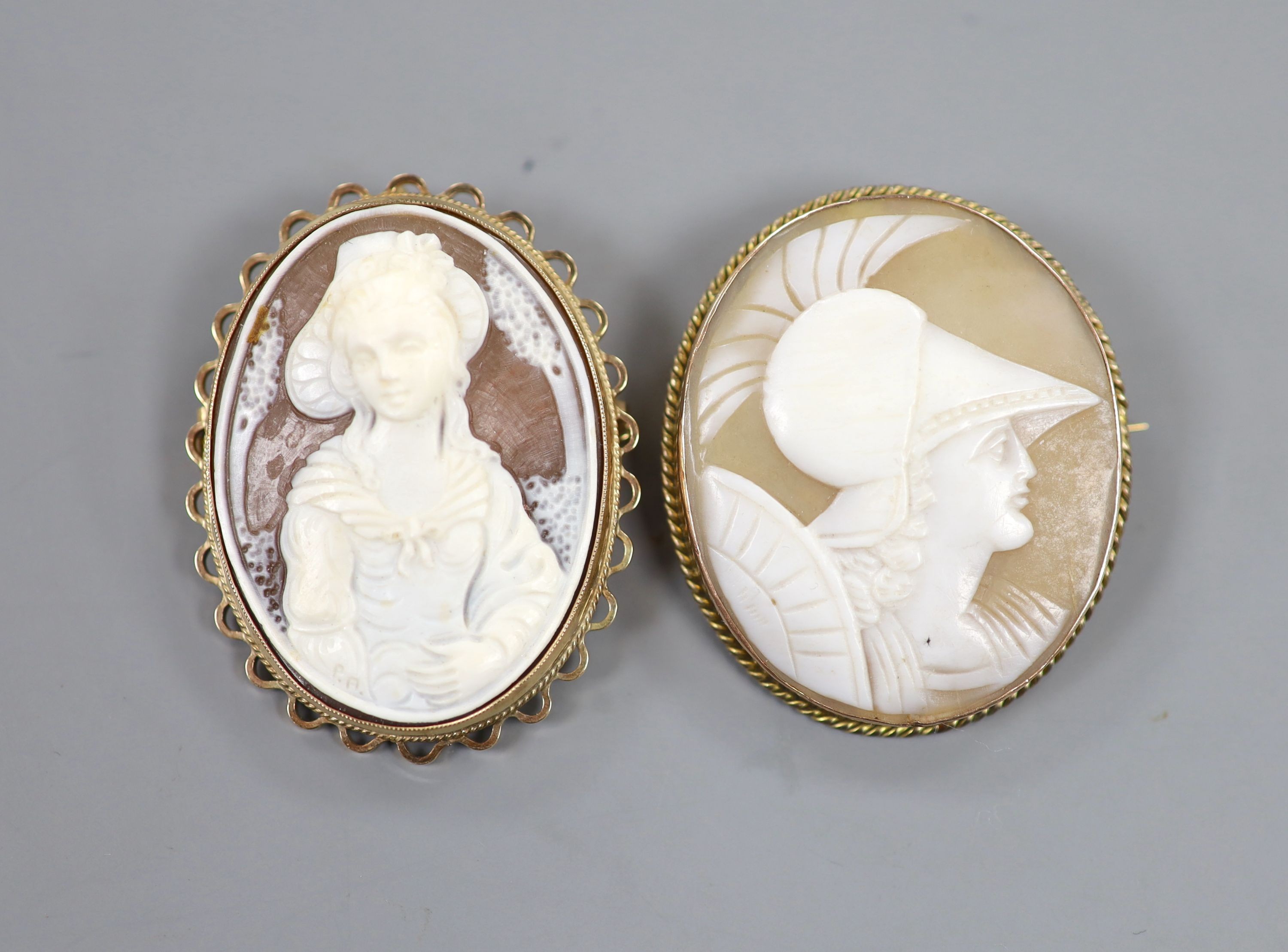 Two 9ct mounted oval cameo shell brooches, one with pendant mount, largest 44mm, gross weight 20