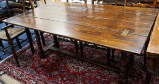 A Titchmarsh & Godwin 18th century style rectangular oak dining table with twin flap folding top,