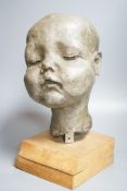 A composition sculpture of a child’s head40 cm high including plinth