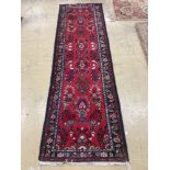 A Hamadan red ground runner with floral design, 280 x 84cm