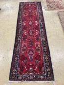 A Hamadan red ground runner with floral design, 280 x 84cm