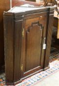 A George III oak hanging corner cabinet, width 80cm, depth 44cm, height 90cm