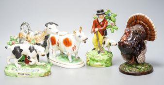 A 19th century 'Milkmaid and cow' creamer with sponged decoration, three other Staffordshire items