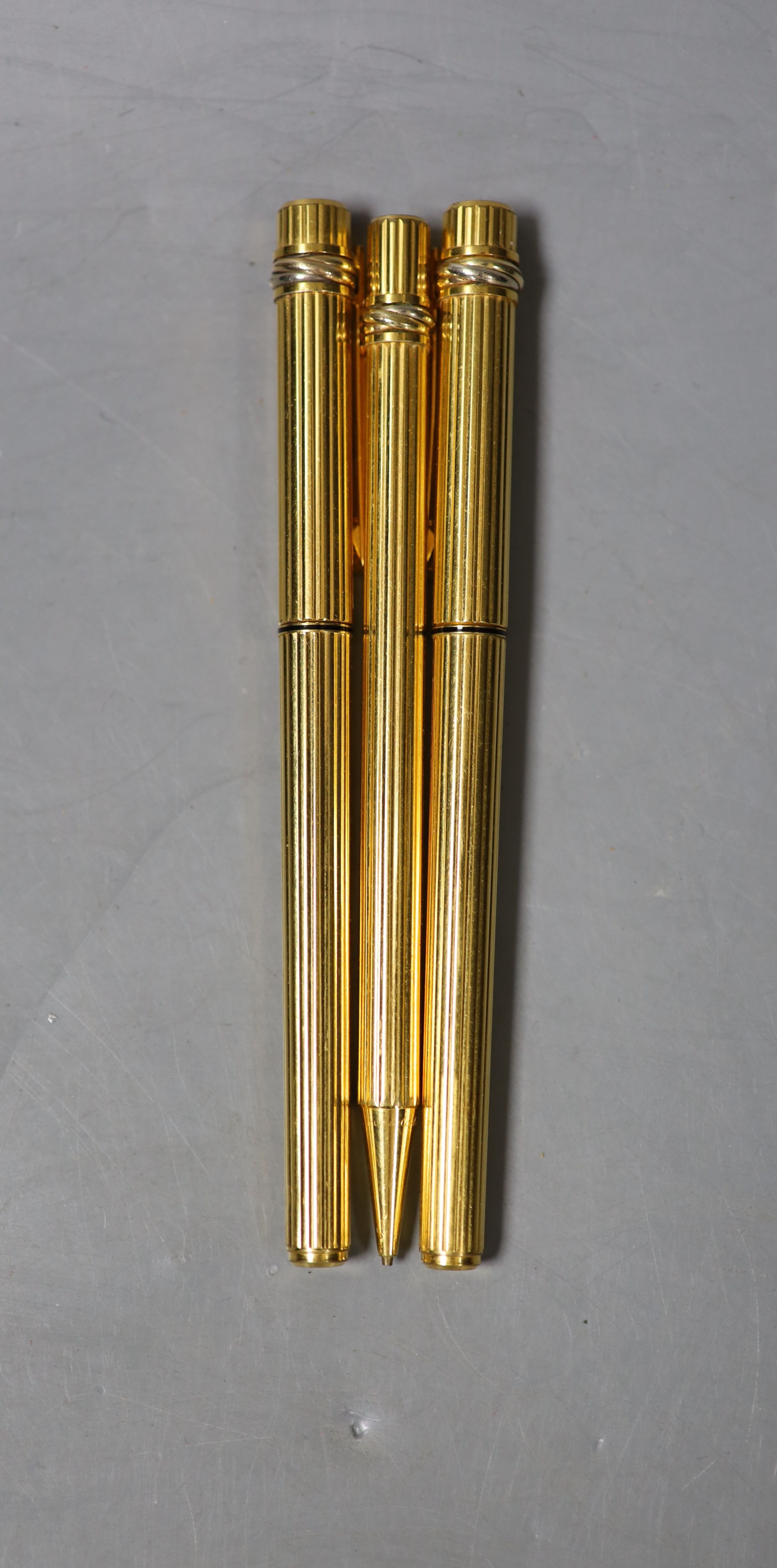 A Cartier gilt metal fountain pen, ball point pen and propelling pencil - Image 2 of 3