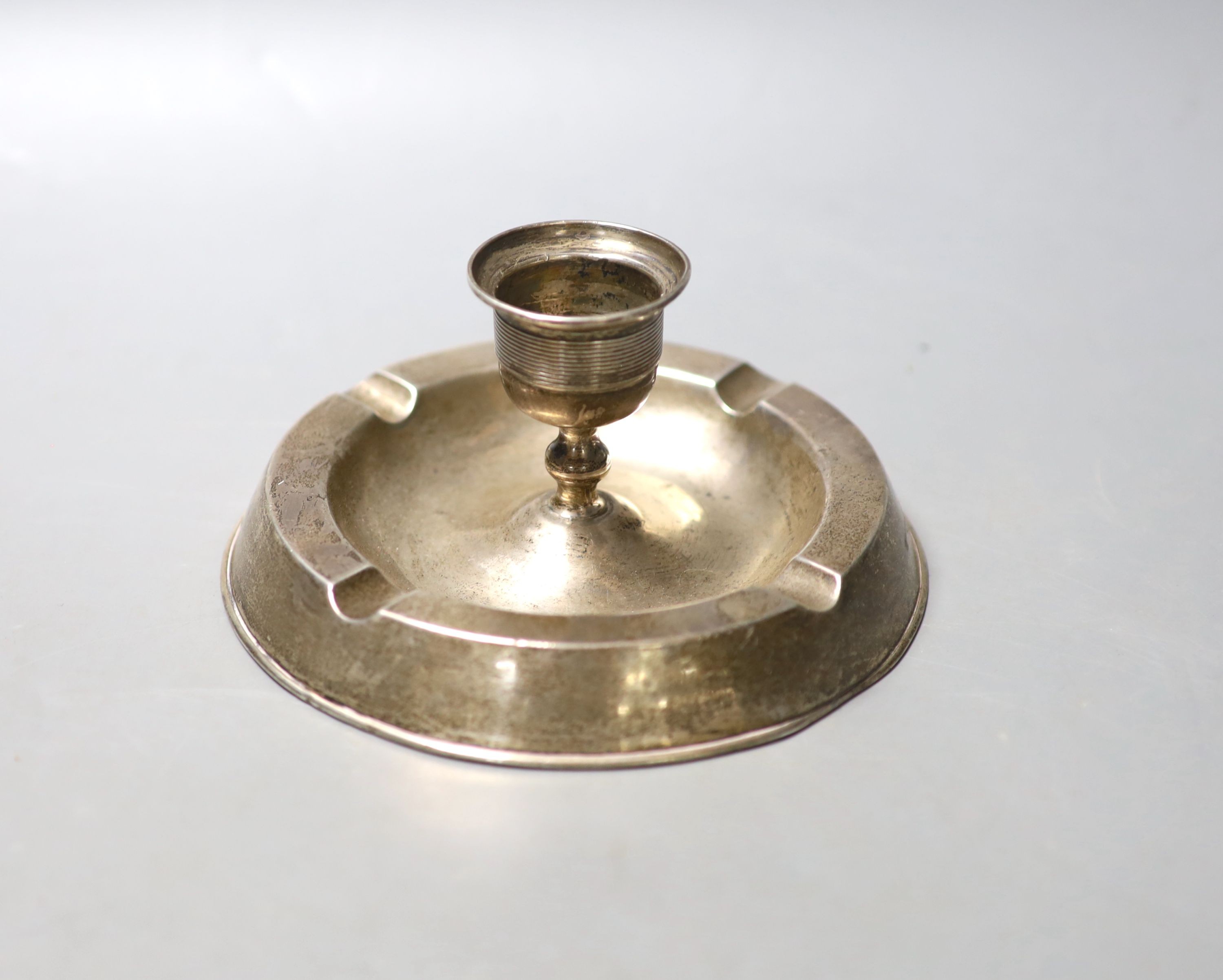 An Edwardian silver mounted combination ashtray/candlestick, Birmingham, 1908, diameter 14.4cm,