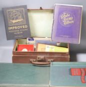 Four stamp albums and a small case containing loose stamps