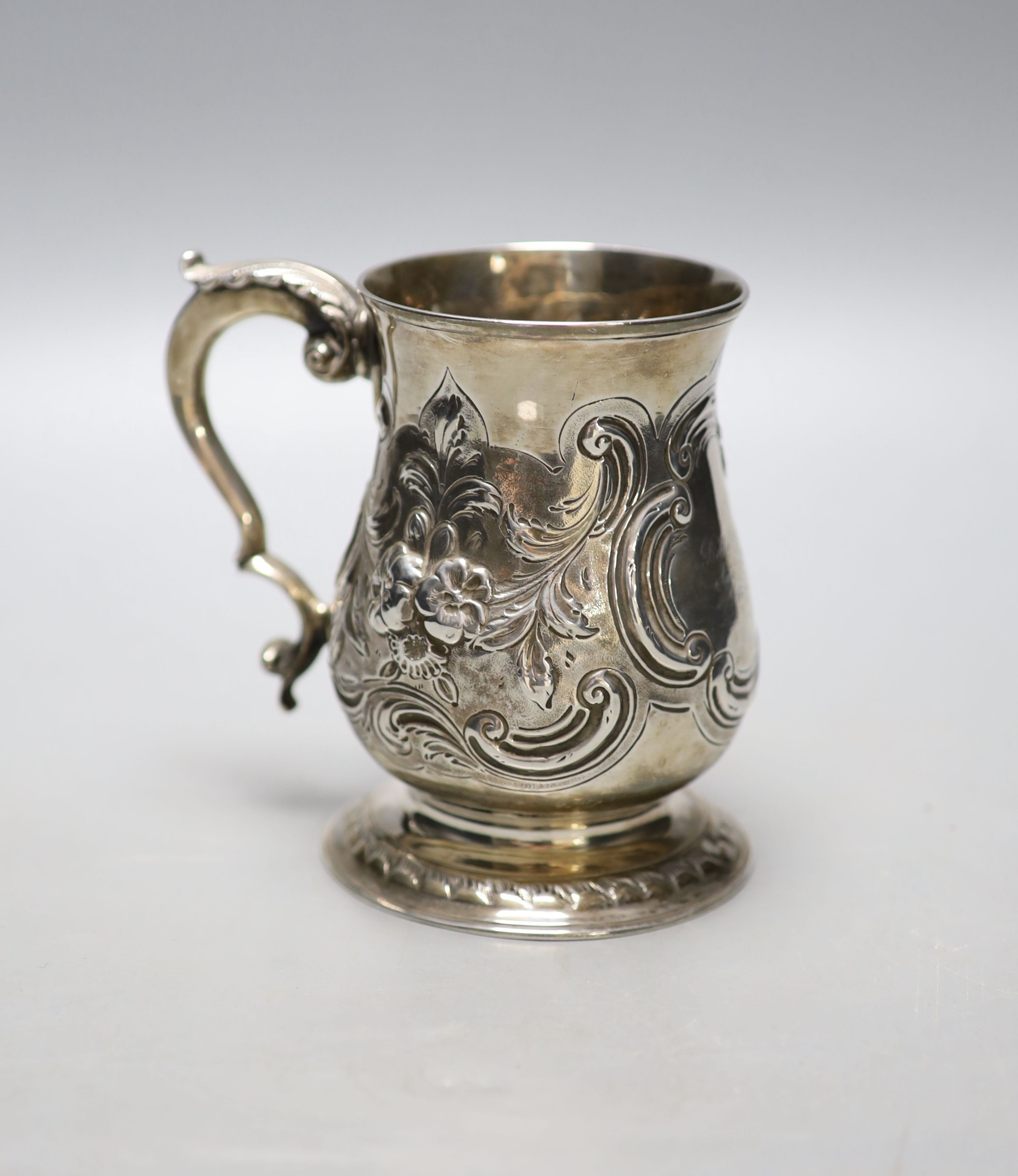 A George III silver baluster mug, with later embossed decoration and later engraved inscription,