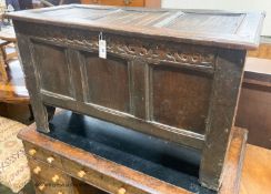 A 17th century caved panelled oak coffer, W.110cm D.48cm H.67cm