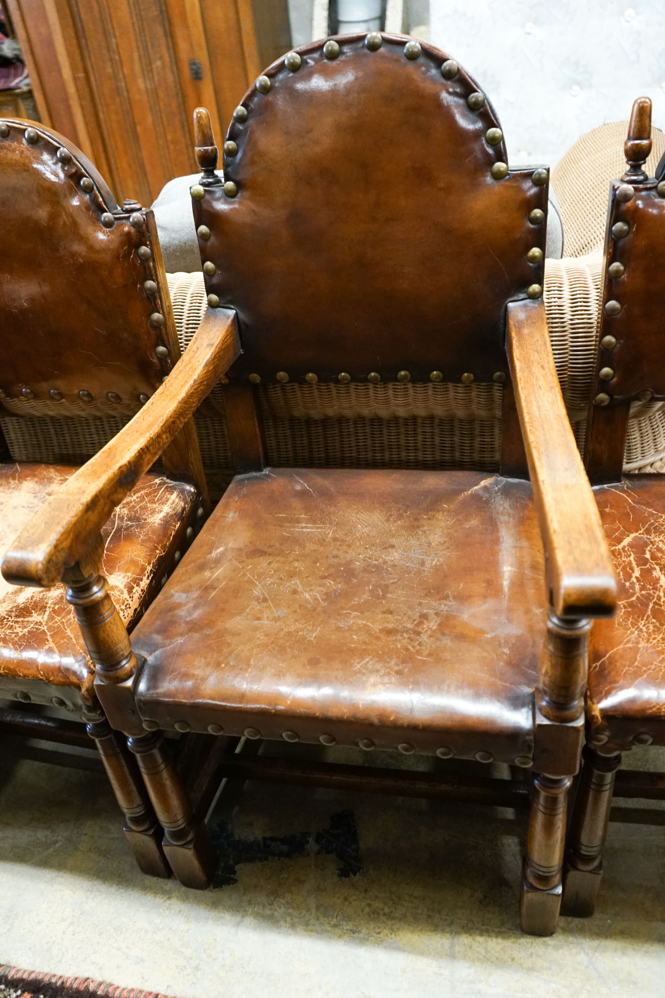 A set of six oak dining chairs,having arched backs and brass-studded brown leather upholstery (two - Image 3 of 4