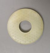 A Chinese pale celadon jade bi disc, 6cm diameter