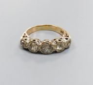 1887A five-stone diamond ring, 9ct white and yellow gold setting, claw-set with carved shoulders,