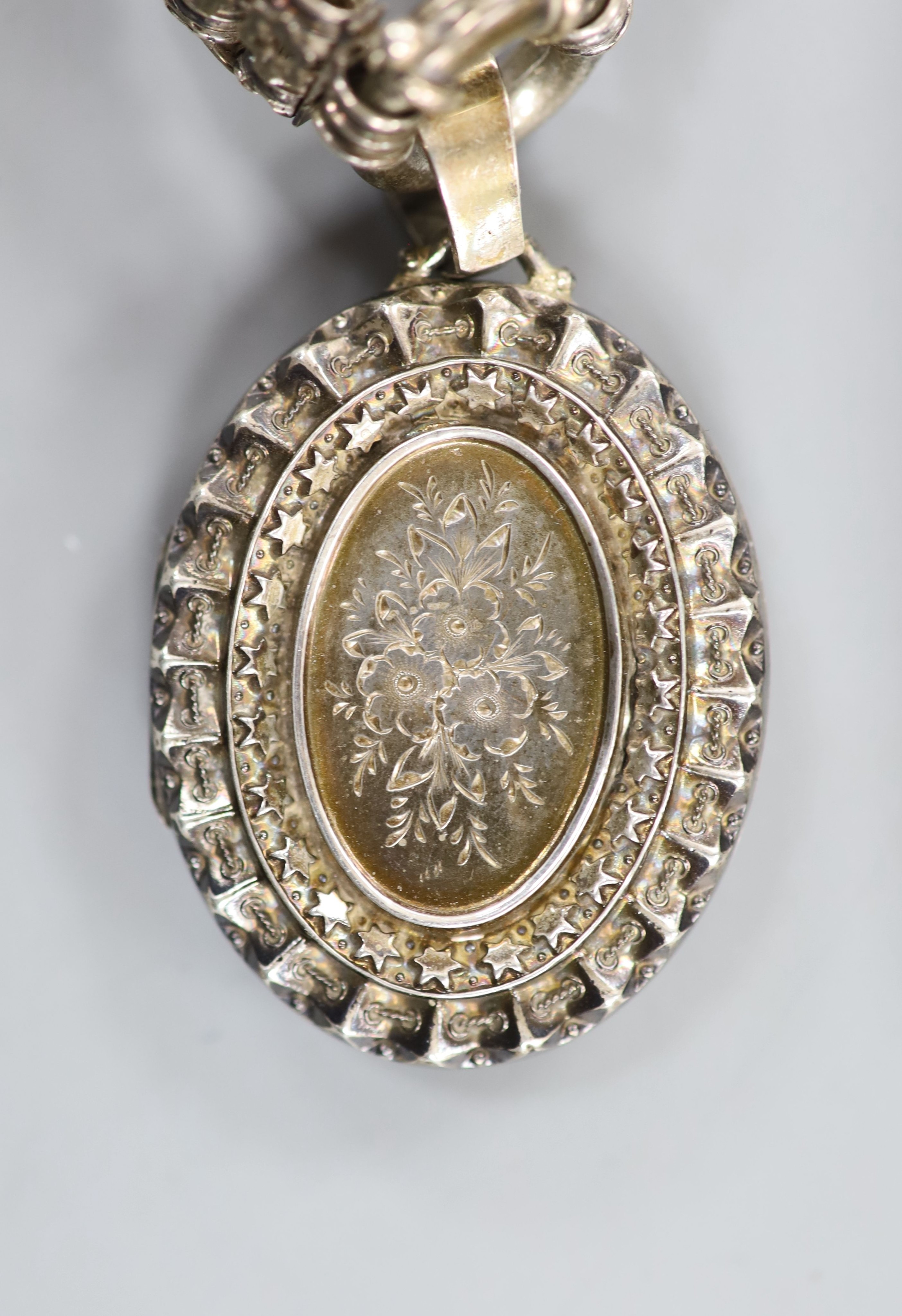 A late Victorian silver oval locket, 45mm, on a pierced white metal chain, 43cm. - Image 2 of 4