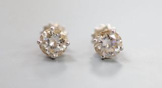 A pair of 18ct white metal and solitaire diamond ear studs, with a total diamond weight of