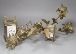 A brass carriage timepiece, a brass casket containing silver watch and a brass rococo-style twin-