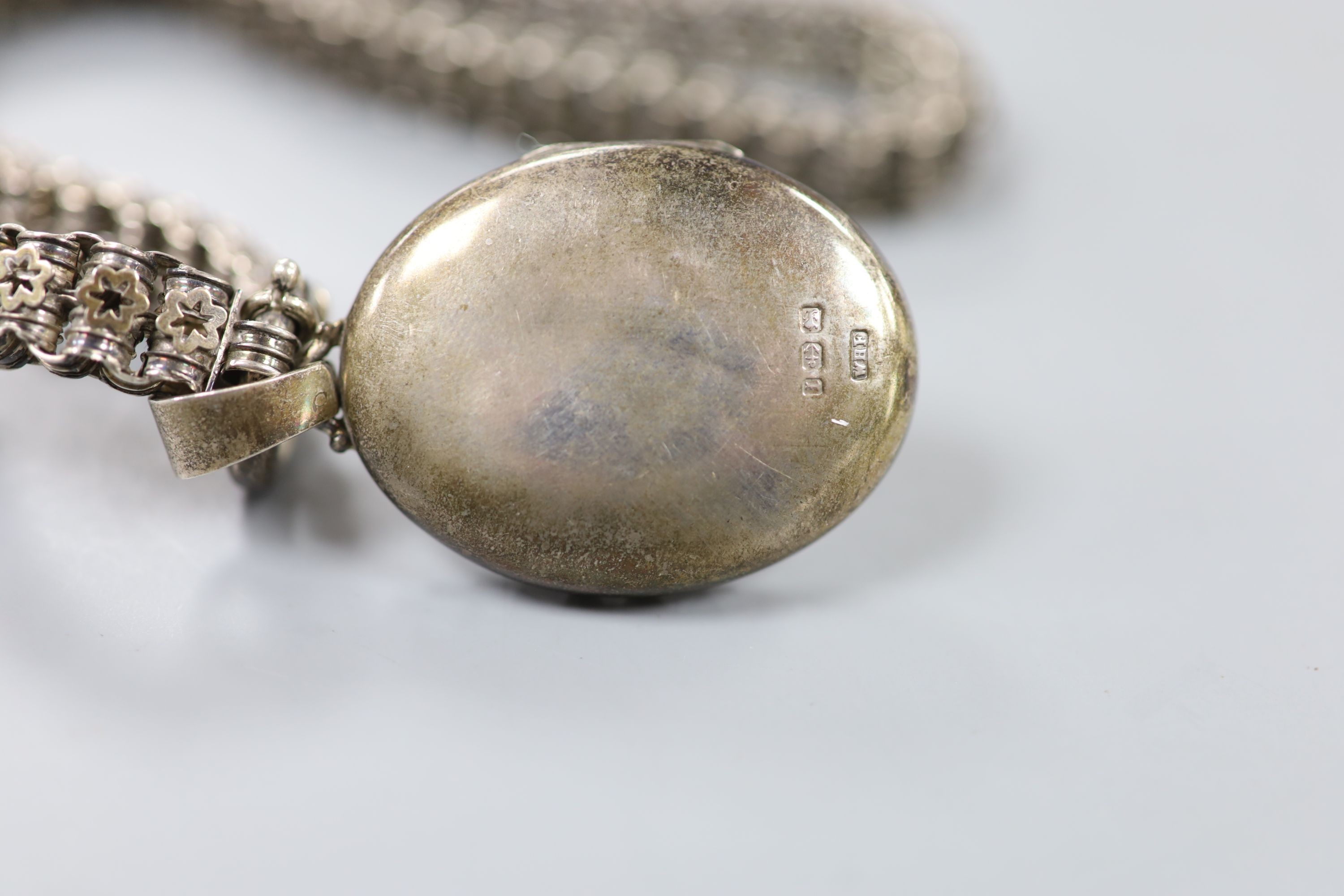 A late Victorian silver oval locket, 45mm, on a pierced white metal chain, 43cm. - Image 3 of 4