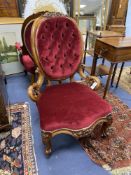 A Victorian carved walnut armchair and matching nursing chair