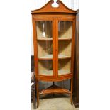 An Edwardian banded satinwood bowfront standing corner cabinet, width 76cm, depth 41cm, height