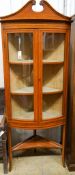 An Edwardian banded satinwood bowfront standing corner cabinet, width 76cm, depth 41cm, height