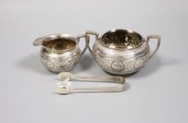 A Victorian engraved silver bachelors cream jug and sugar bowl and pair of matching sugar tongs,
