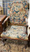 An 18th century French carved walnut elbow chair with tapestry upholstery, width 60cm, depth 58cm,