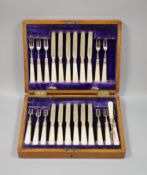 An Edwardian cased set of twelve pairs of mother of pearl handled silver dessert eaters, John