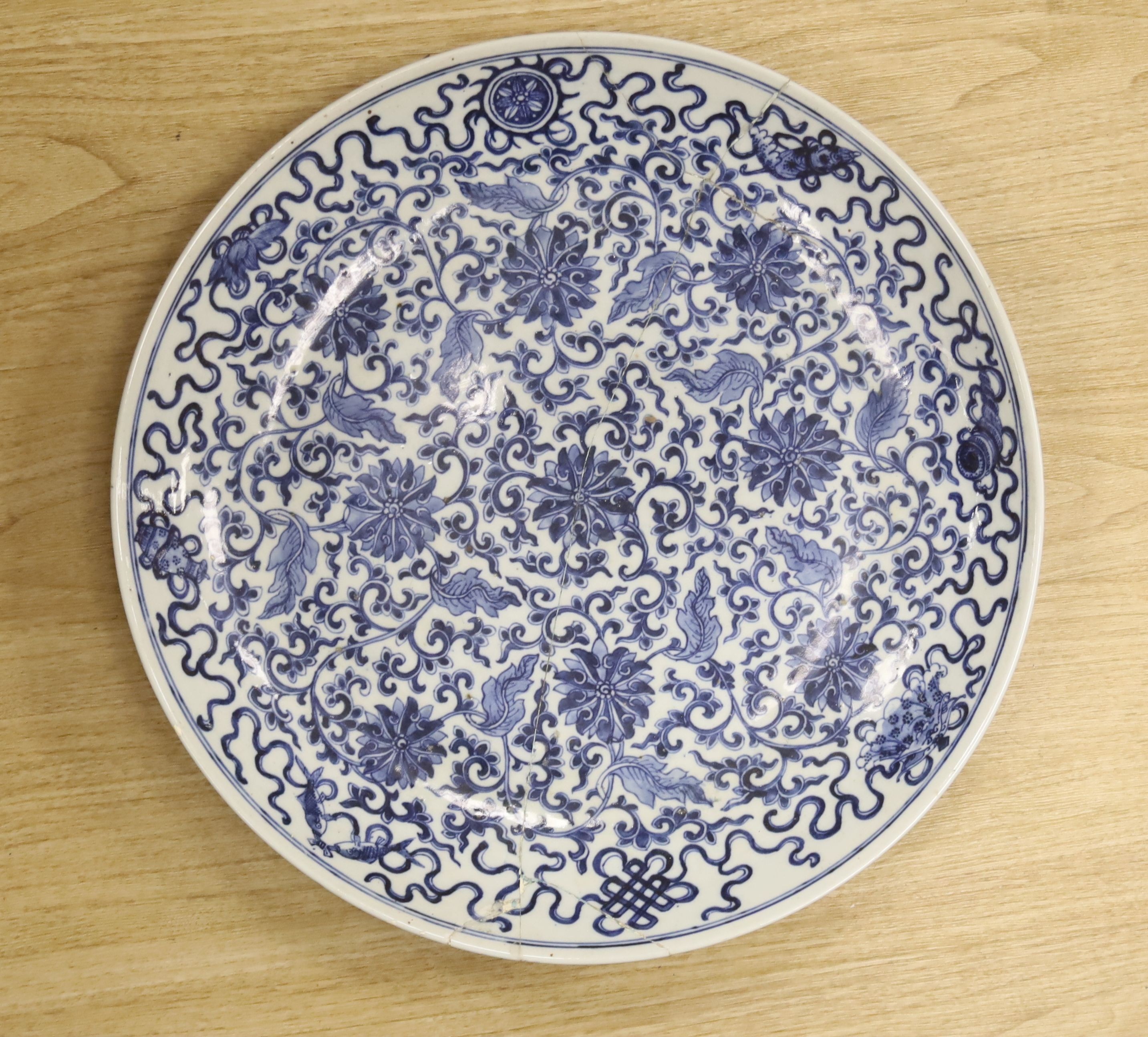 A large Chinese blue and white 'lotus and eight Buddhist emblems' dish, Daoguang period, repaired.