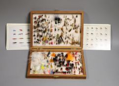 A cased collection of various fishing flies