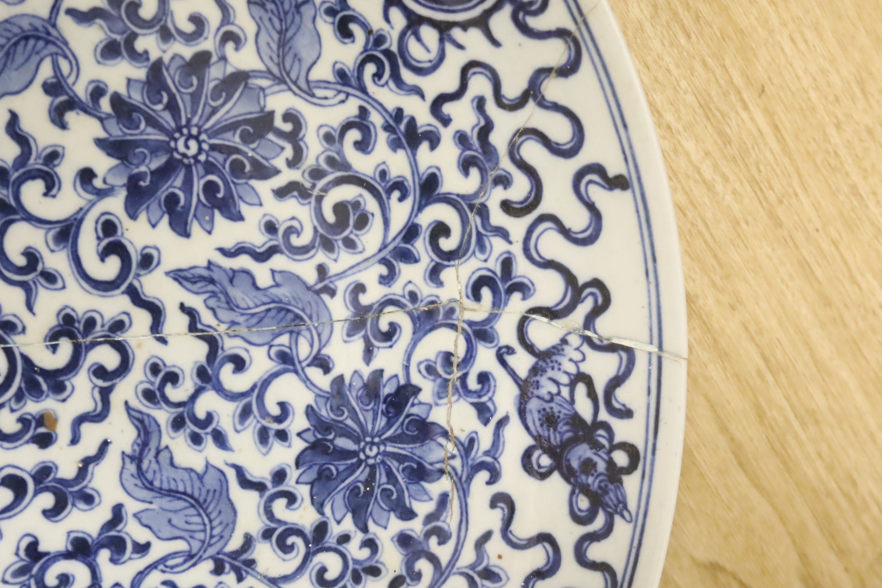 A large Chinese blue and white 'lotus and eight Buddhist emblems' dish, Daoguang period, repaired. - Image 2 of 3